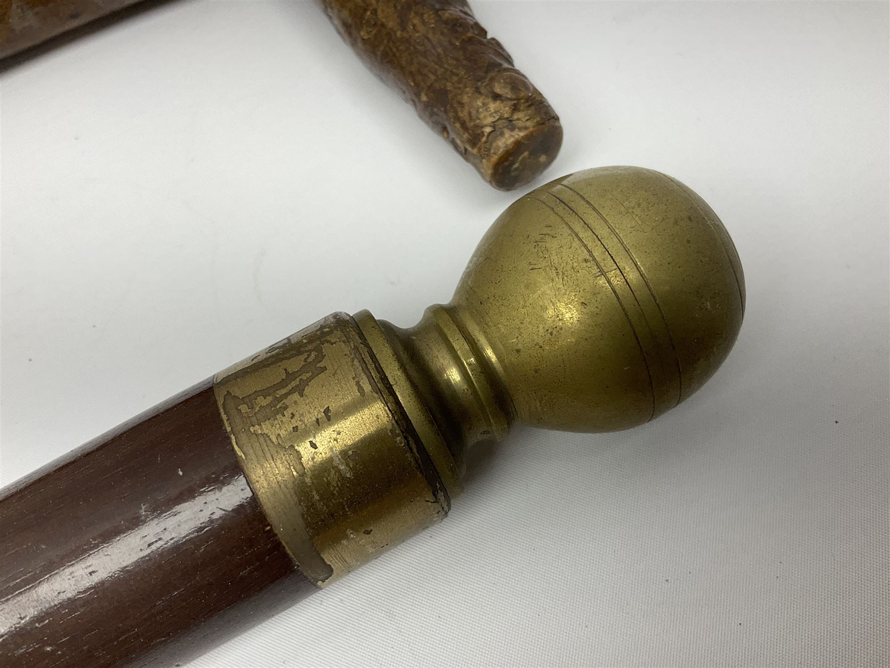 Four wooden walking canes, including a carved mahogany snooker cue example, tallest H86cm