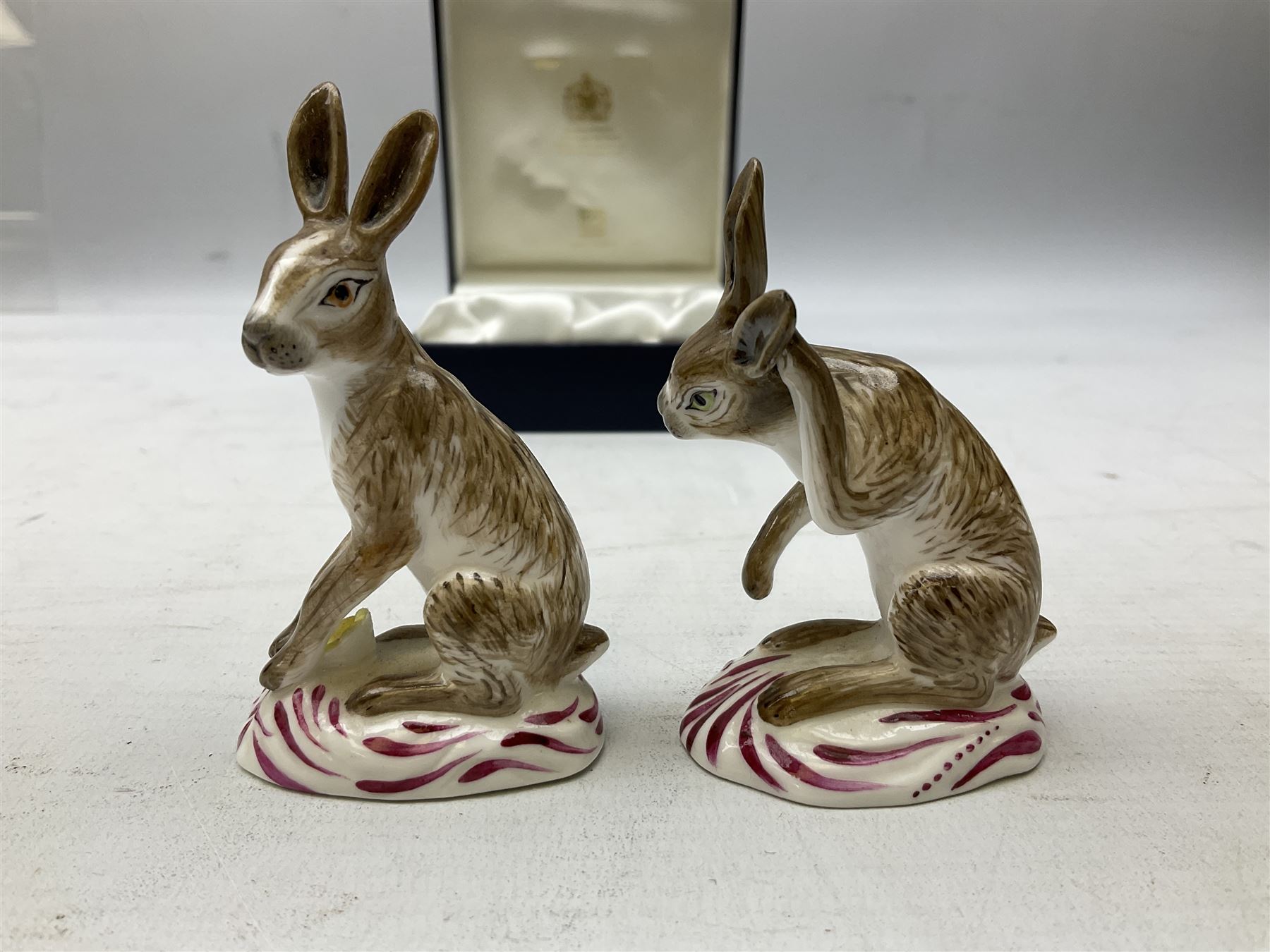 Two Halcyon Days porcelain figures of hares, inspired by Bow porcelain hare c1755, in box 
