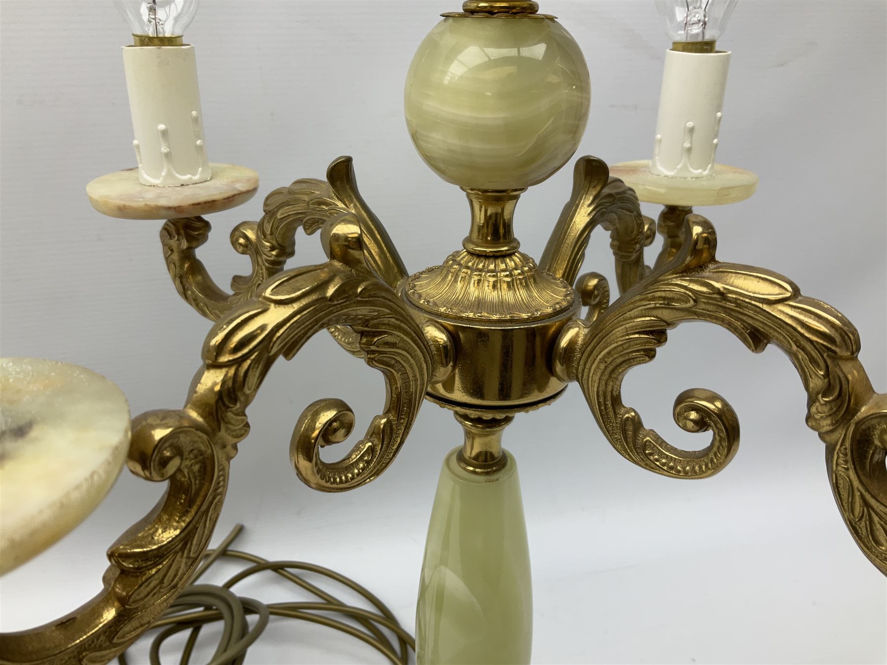  20th century gilt metal and onyx four branched candelabra upon a circular base, and onyx table lamp in the form of an urn, tallest example H48cm