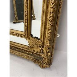 Gilt Rococo style mirror, arched top with central cartouche and oak leaf moulded pediment, floral and fruit moulded surround with segmented glass panels, bevelled central pane, c-scroll shell and acanthus leaf brackets