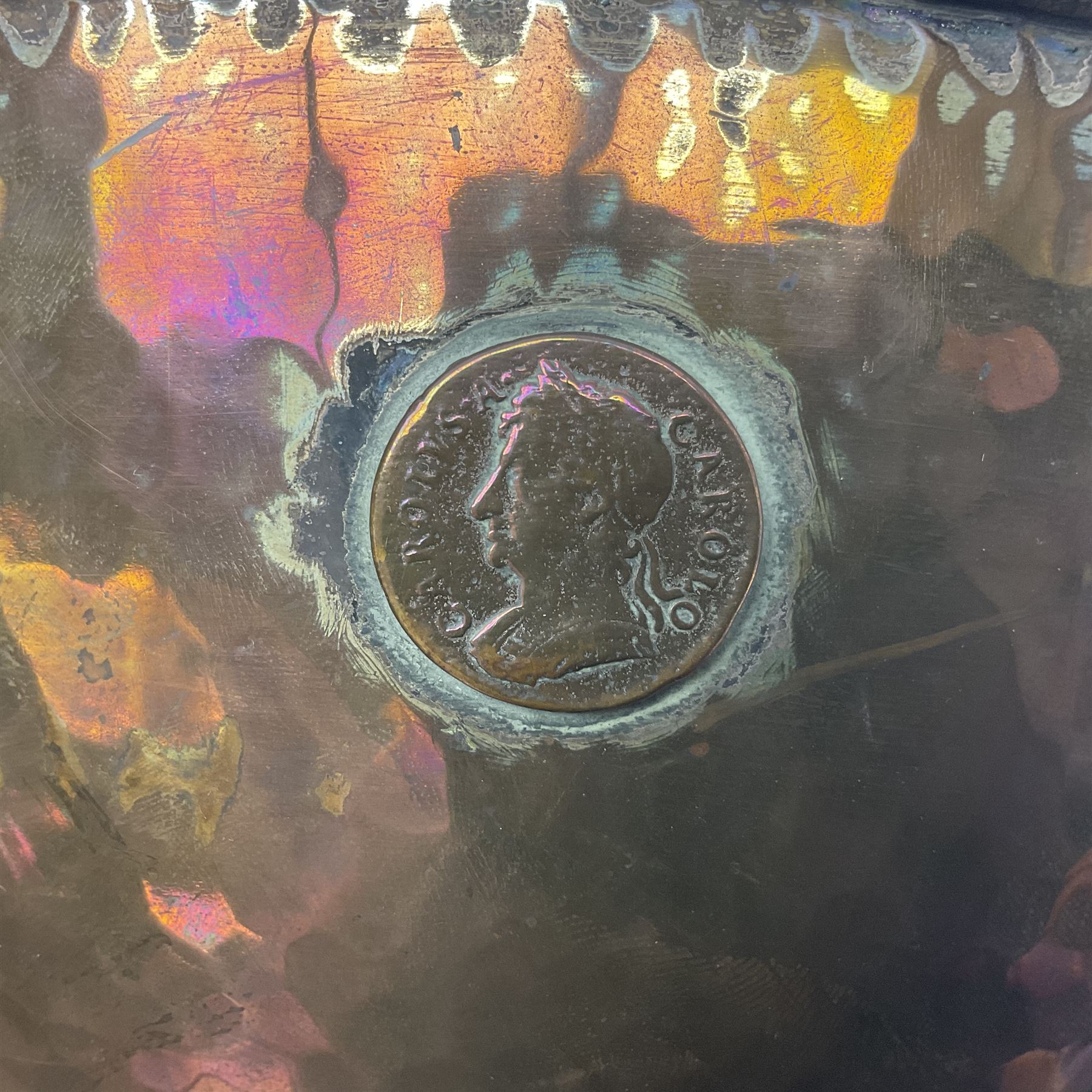 Copper pedestal punch bowl, with planished decoration with twin lion mask and ring handles and applied coins, H18cm