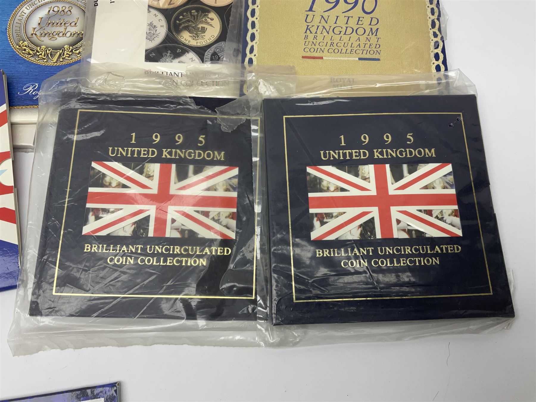 Fourteen Queen Elizabeth II United Kingdom uncirculated coin collections, dated 1983, 1984, two 1985, 1986, 1987, 1988, 1989, 1990, 1991, 1992 including dual dated 1992/1993 EEC fifty pence, 1994 and two 1995, all in card folders