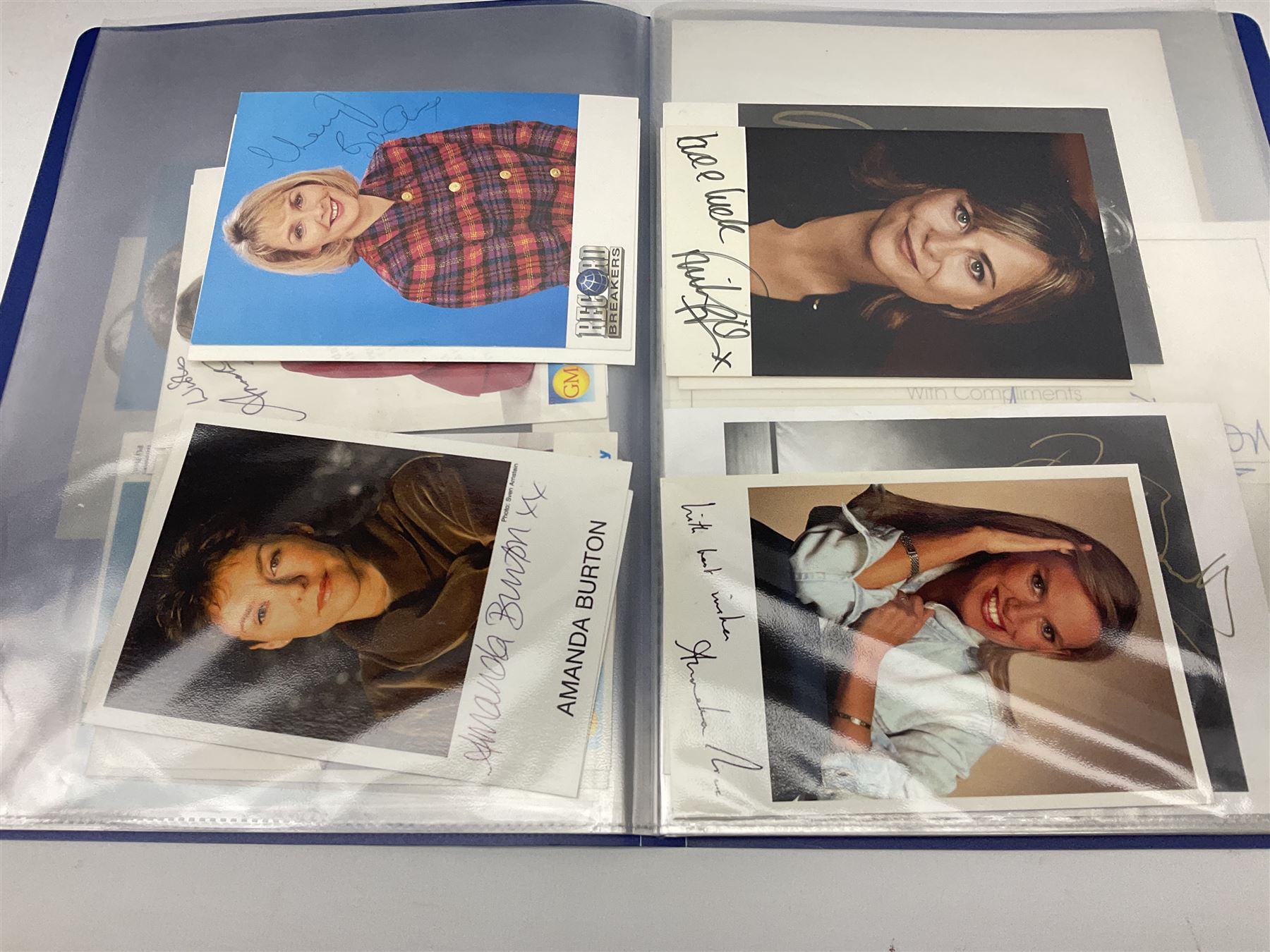 Two folders of over fifty photographs, cards, compliment slips etc of actors, actresses, celebrities, politicians, sports personalities etc, all bearing signatures, including David Frost, Lloyd Grosman, John Suchet, Julia Somerville and othe GMTV presenters, Carol Vorderman, Jackie Collins, Rolf Harris, Timothy Dalton, Pete Postlethwaite, Magnus magnusson, John Major, Kate Moss, Uri Geller, David Beckham, Peter Alliss, Sharon Davies, Kevin Keegan etc