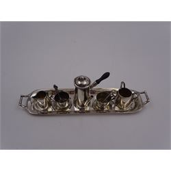 Edwardian miniature silver tea set, comprising hot chocolate pot, two cups and saucers, milk jug, sugar bowl and tray, hallmarked Cornelius Desormeaux Saunders & James Francis Hollings (Frank) Shepherd, Chester & Birmingham 1908, with two spoons and pair sugar tongs, hot water pot H3.8cm