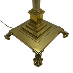 Late 20th century brass telescopic standard lamp in the form of a Corinthian column, Corinthian acanthus leaf capital over reeded shaft, stepped and moulded square base with four extending ball and claw feet
