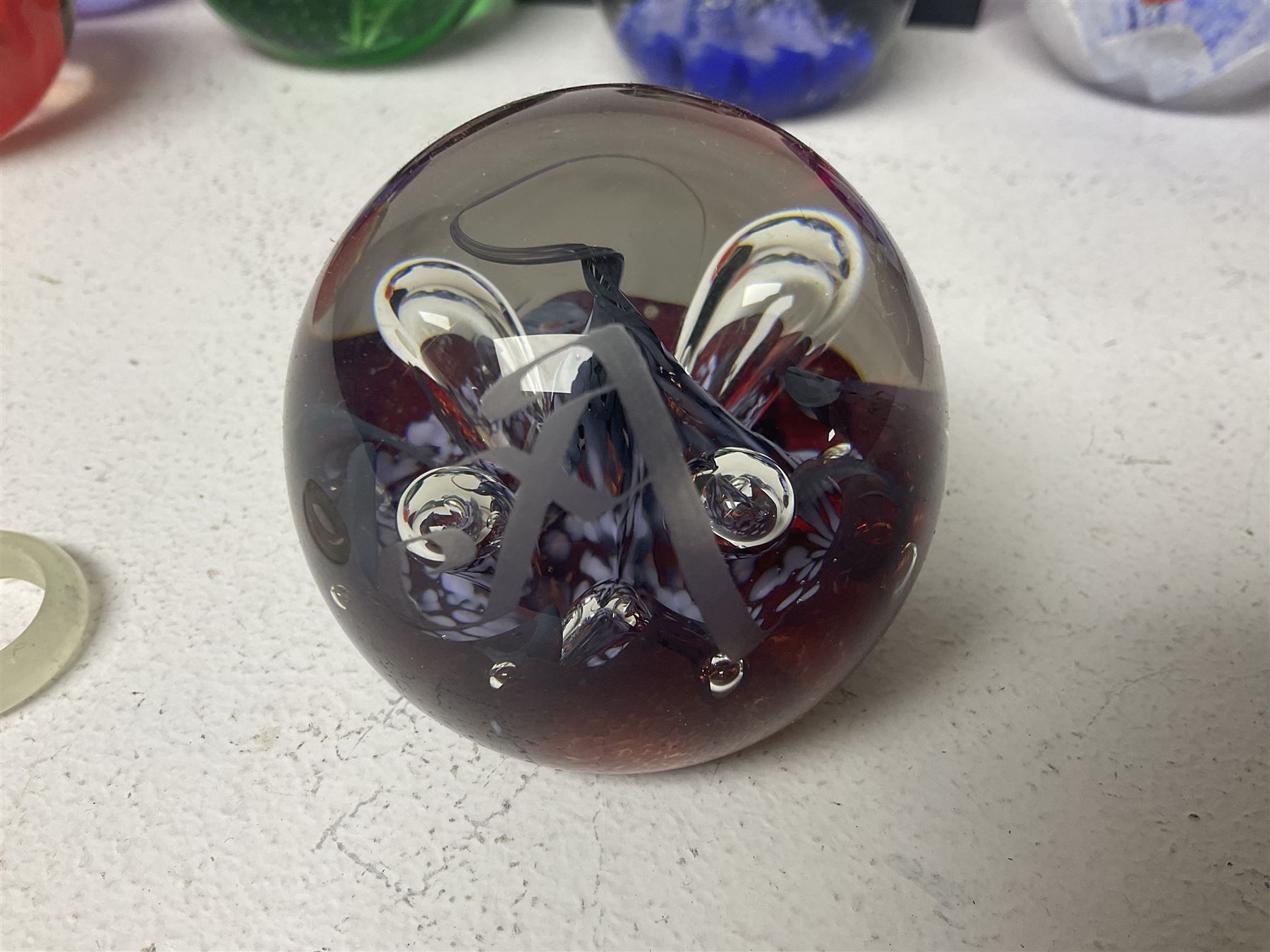 Twelve Caithness glass paperweights, to include Pastel, Mooncrystal and Fiesta, together with Baccarat 'The Princess Anne' paperweight and two Mdina examples (15)