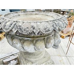 Pair of large weathered Country House Haddonstone garden urns, acanthus carved rim above gadrooned bowl, beaded detailing to the neck, raised on stepped double plinth base
