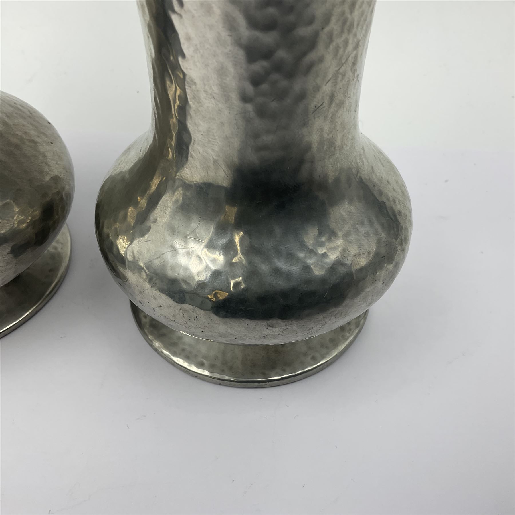 Pair of Liberty & Co Tudric pewter vases, each of bellied form with hammered finish, upon a circular spreading foot, impressed beneath 0987, H12cm