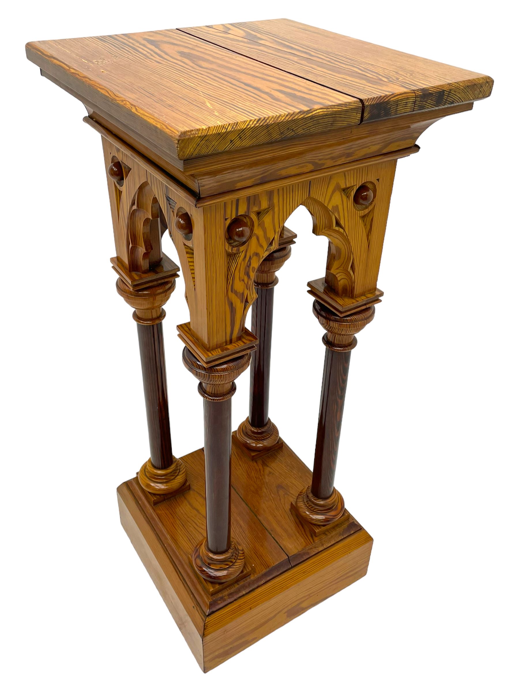 19th century pitch pine ecclesiastical pedestal stand, the square chamfered top over cusped Gothic pointed arches and four turned column supports, stepped and moulded plinth base