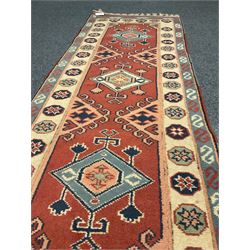 Turkish style runner rug, triple medallion surrounded by red field, inner floral boarder and patterned outer 