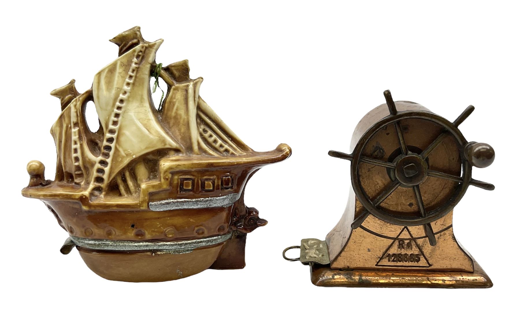 Copper tape measure in the form of a ship`s wheel, marked 'Rd. 128885' to the front, and a celluloid tape measure in the form of a galleon, wheel H4cm