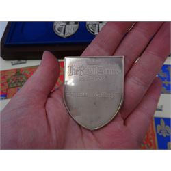 Yorkshire Mint, The Royal Arms Collection, twelve shield shaped silver medallions each depicting variations on the Royal coat of arms, each hallmarked Yorkshire Mint, Birmingham 1976/77, contained within fitted wooden case with associated information cards