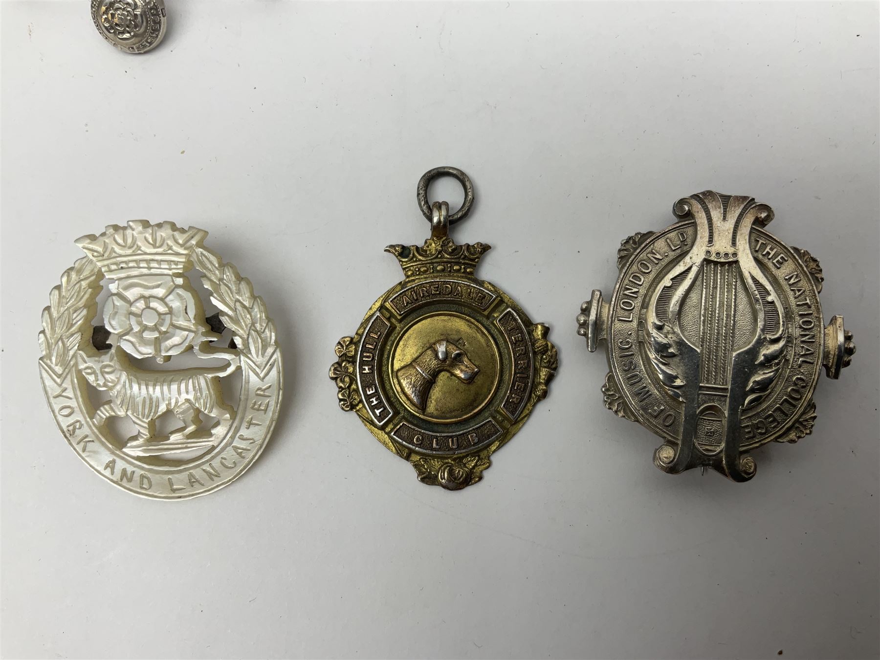 Collectables, to include enamelled Gothic Florin, Hull Rudston and Preston 1811 one shilling six pence token, silver gilt Hull Airedale Terrier Club fob, silver and tortoiseshell badge inscribed East Yorkshire beneath Yorkshire Rose, polychrome enamel buckle, mother of pearl badge carved with rose and tiger and inscribed York & Lancaster, etc.