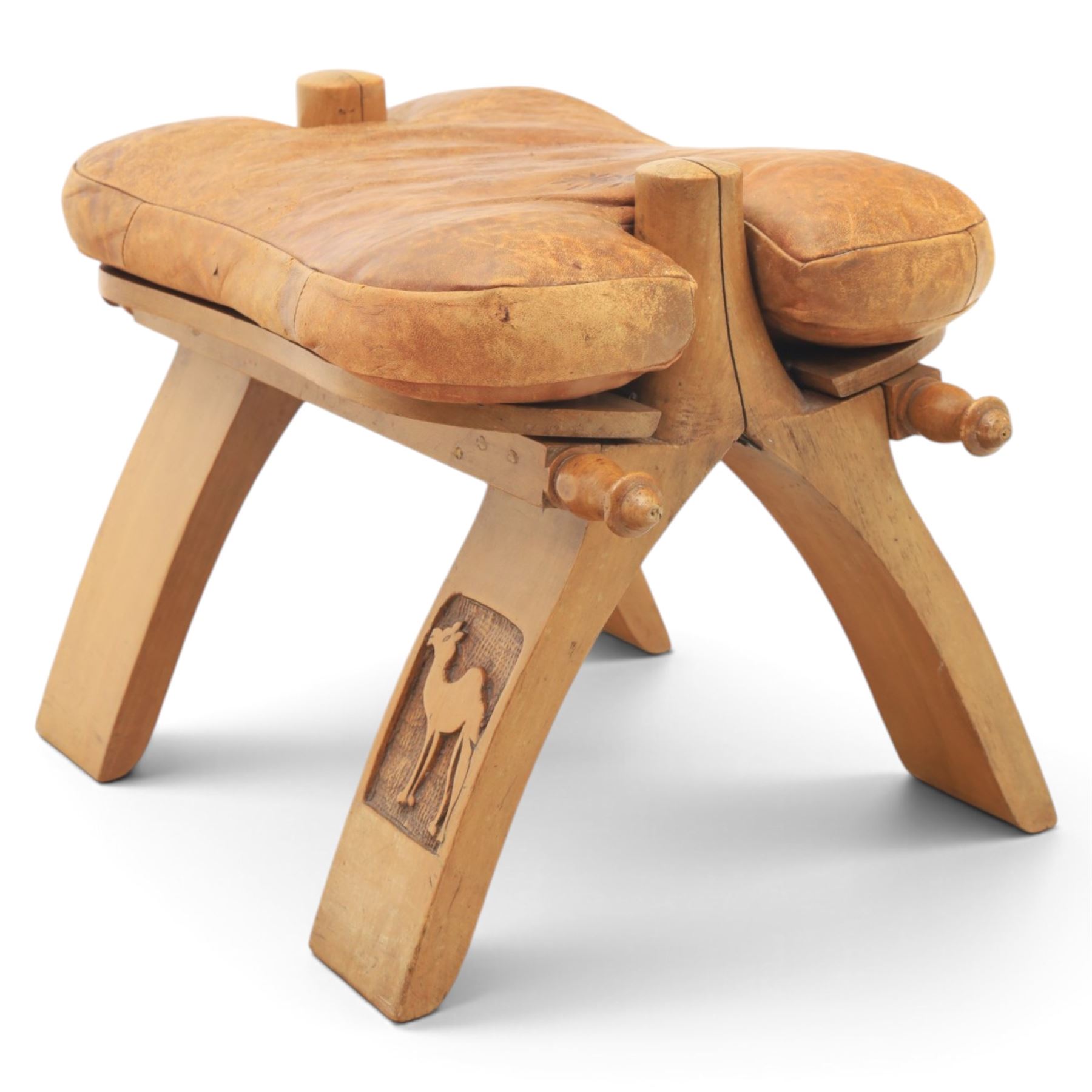 20th century Camel stool, tan leather seat with tooled design, raised on a light wood carved frame with camel design