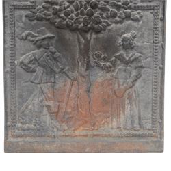 Cast iron fire back, depicting a couple under a tree with three acorn finials, H74cm