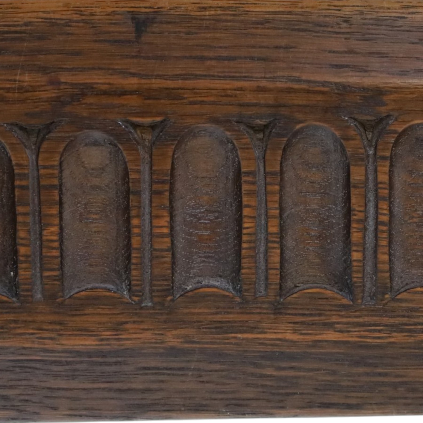 Rupert Griffiths for Monastic Woodcraft - oak 6ft refectory dining table with set six (4+2) matching chairs, rectangular top with arcaded frieze, with trestle base with further arcaded carved stretchers, chairs with carved rails and finials, leather wrapped seats with stud detail, turned supports united by carved stretcher