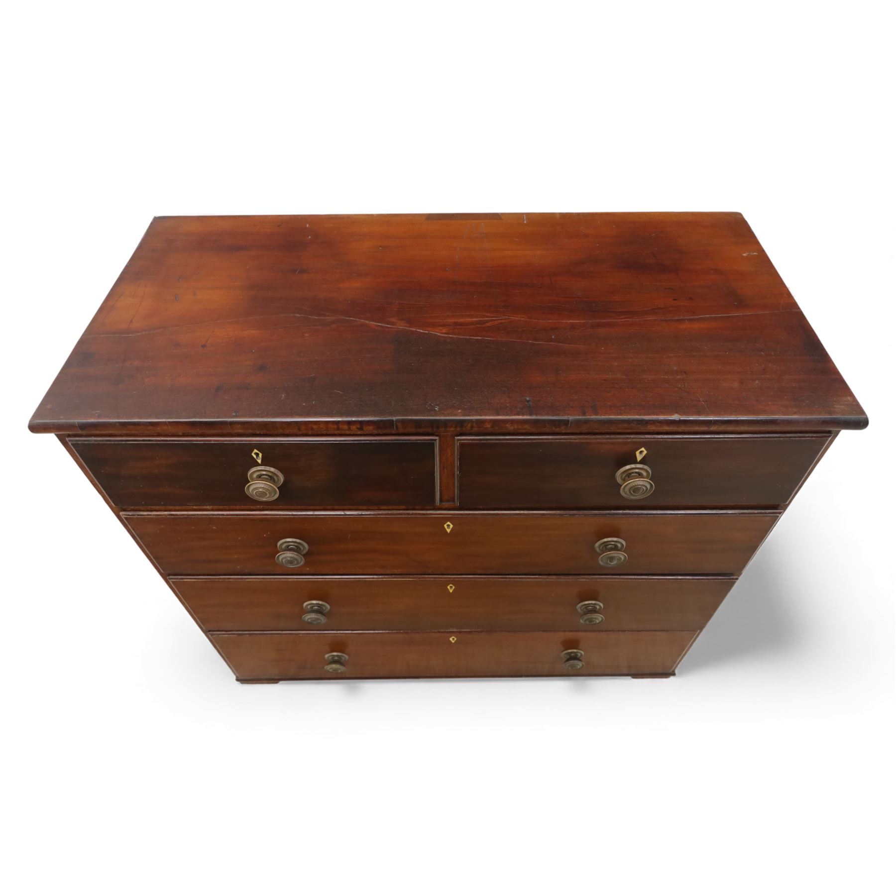 19th century mahogany chest, with a rectangular top over two short and three long graduated drawers fitted with turned knobs and bone escutcheons, raised on shaped bracket feet