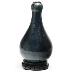 Chinese Jun type  bottle shape vase with tonal blue glaze with unglazed foot on wooden sta...