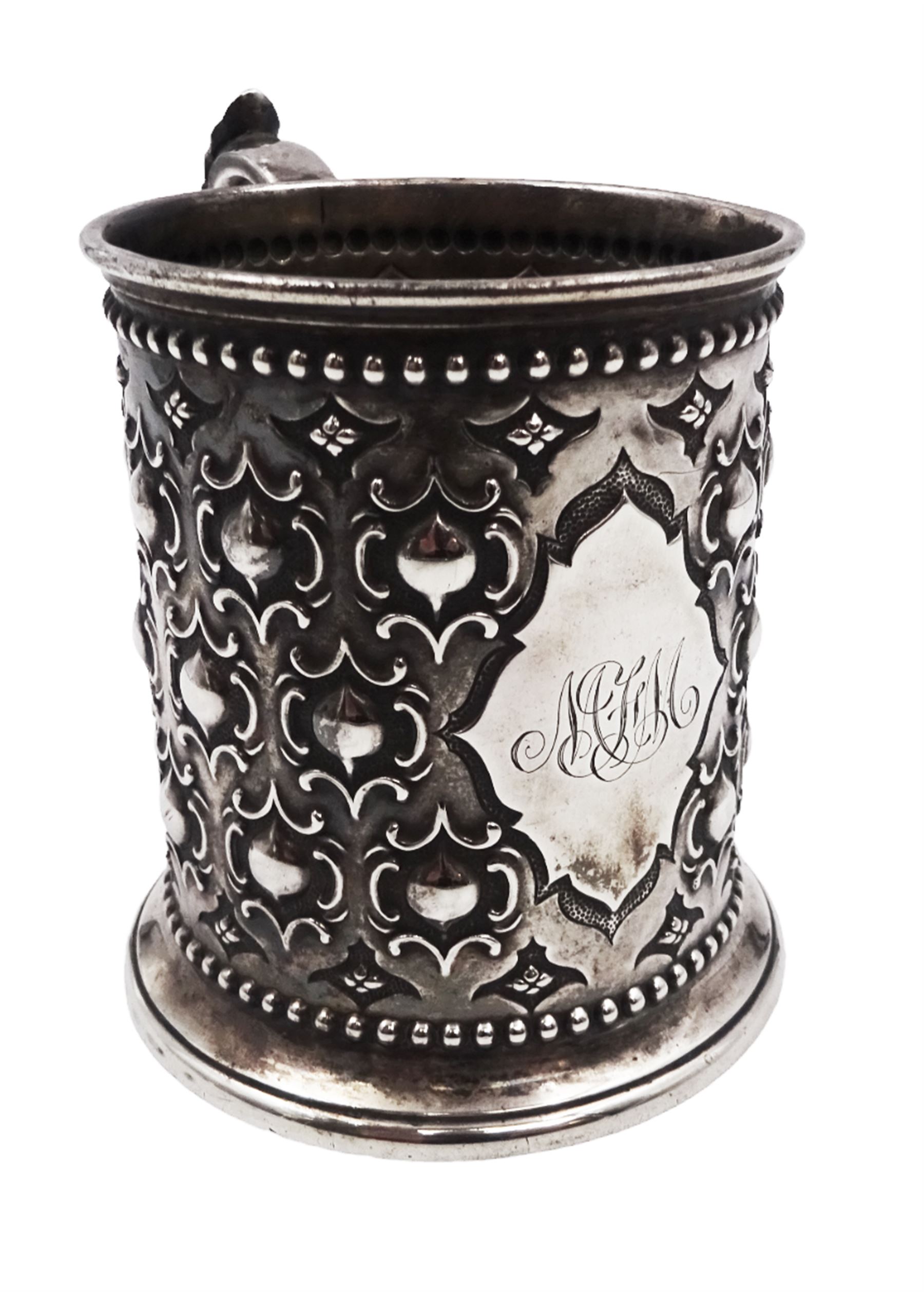 Victorian silver christening mug, with repousse and chased scroll and bead decoration, lozenge shaped cartouche engraved with monogrammed initials and acanthus capped C scroll handle, hallmarked Robert Hennell III, London 1861, H9.3cm