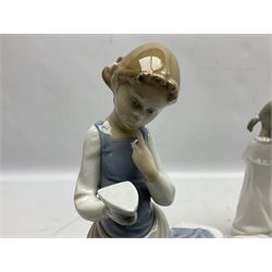 Four Lladro figures, comprising Ironing Time no 4981, Boy with Dog no 4522,  Boy Awakening no 4870 and Teaching to Pray no 4779, together with two Lladro plaques, largest example H26cm