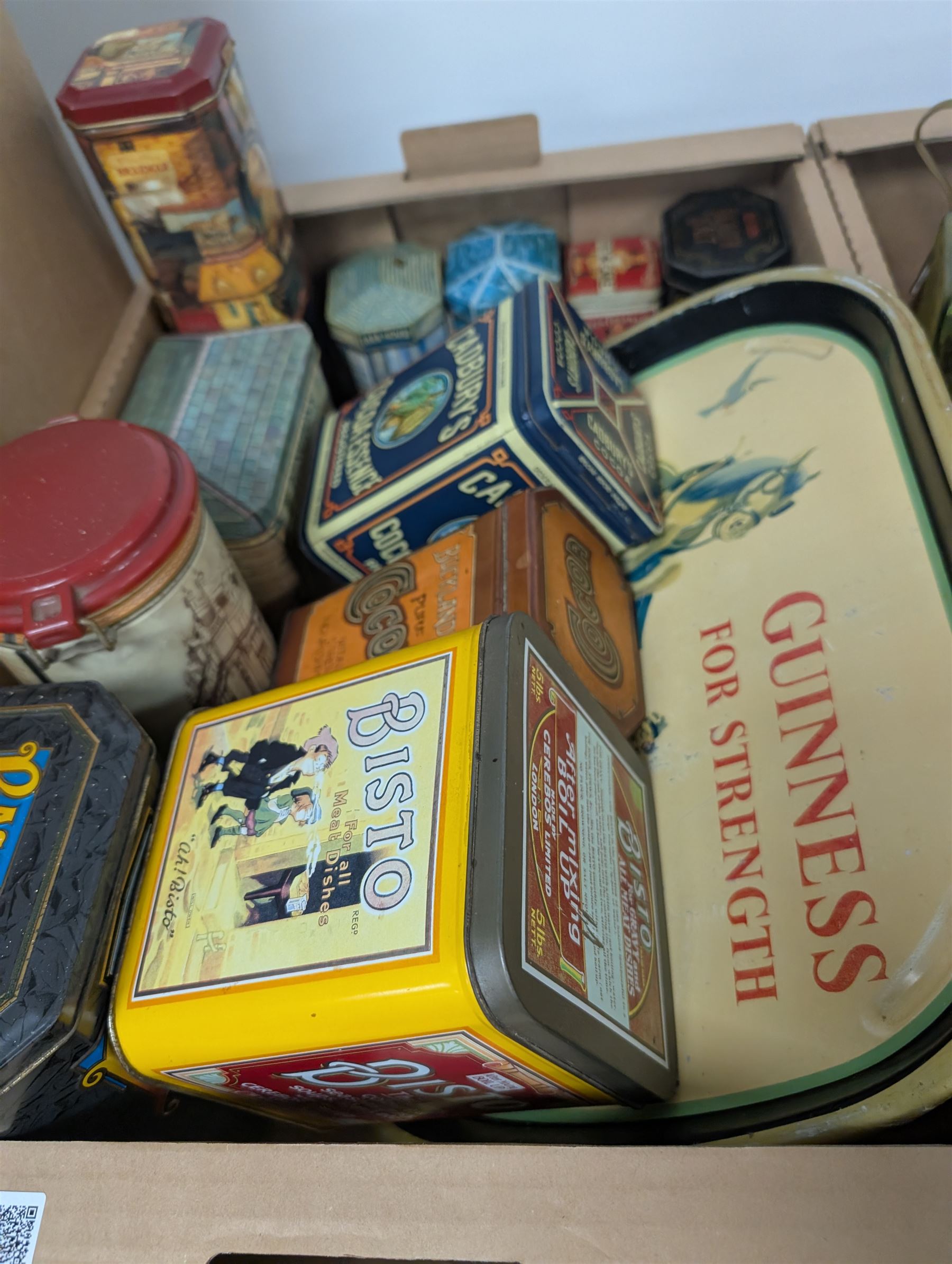 Collection of advertising tins, including Bisto and Cadburys, together with a Guinness 'For Strength' metal tray, brass measures, glass bottles, Royal Crown Derby cat paperweight, etc
