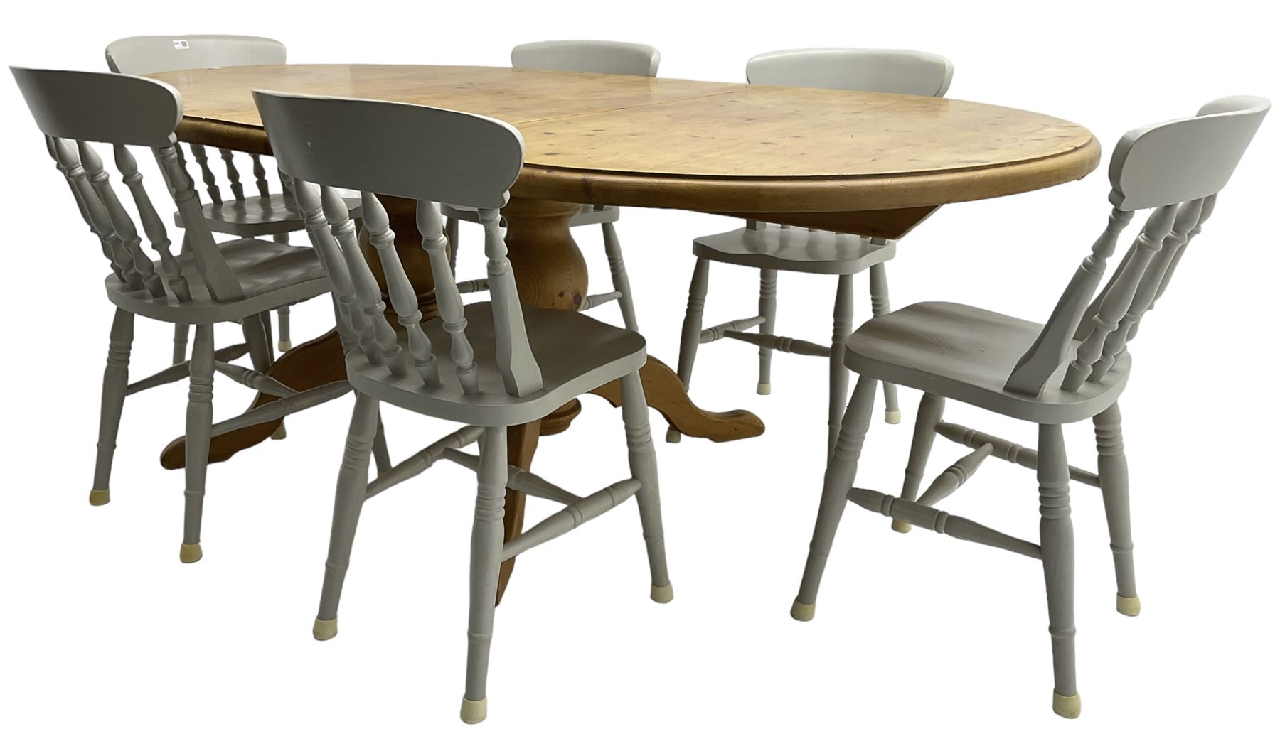 20th century pine extending dining table, oval top over twin bulbous turned pedestal base united by stretcher, with additional leaf (W160cm D120cm H79cm); and set of seven ash painted dining chairs, spindle back, raised on ring turned supports joined by H-stretcher