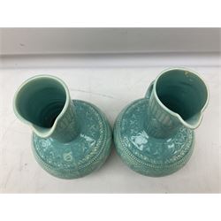Pair of Lear pottery jugs with a blue ground and floral decoration, both with impressed print beneath, H25cm 