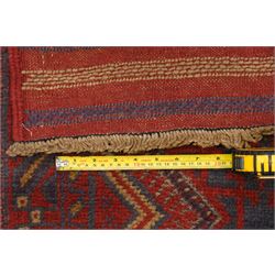 Near pair of Afghan Meshwani runner rugs, each with four red lozenge medallions on a blue ground interspersed with hooked geometric motifs, enclosed by patterned red borders, striped kilim end panels (2)