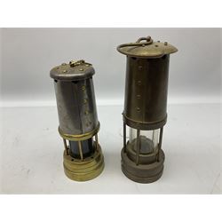 Two miners lamps comprising an E Thomas & Williams Ltd example and a Lamp & Limelight Company example 