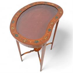 Edwardian satinwood kidney-shaped bijouterie table, hinged lid with glazed panel enclosed by floral painted frame, on square tapering supports decorated with trailing bell flowers, united by shaped stretchers and oval tier painted with ribbon and trumpets 