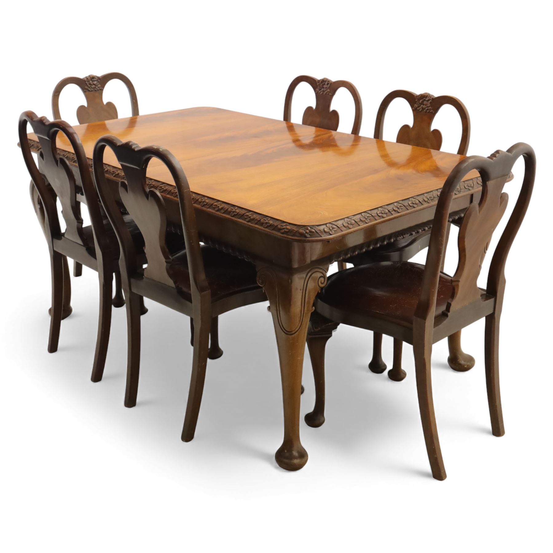 Queen Anne design walnut dining suite, comprising a rectangular dining table with carved moulded edge and rounded corners, raised on cabriole legs terminating in pad feet, together with a set of six matching dining chairs, each with shaped splat back, leather upholstered seat and cabriole supports (Extends to 230cm)
