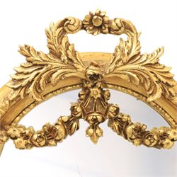 Louis XVI style giltwood pair of wall mirrors, arched frames with moulded borders, surmounted by ribbon tied floral crestings and trailing husk swags, enclosing bevelled mirror plates
