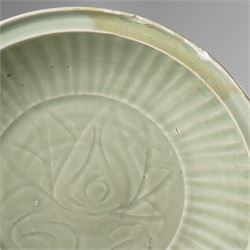 Chinese Ming dynasty Longquan celadon dish, the base carved with a lotus within a ribbed surround D35cm