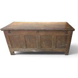Large 17th century oak coffer, plank top with moulded edge, four panel front with channel moulded uprights, retaining original wrought iron strap hinges and central lock plate, panelled ends, raised on stile supports