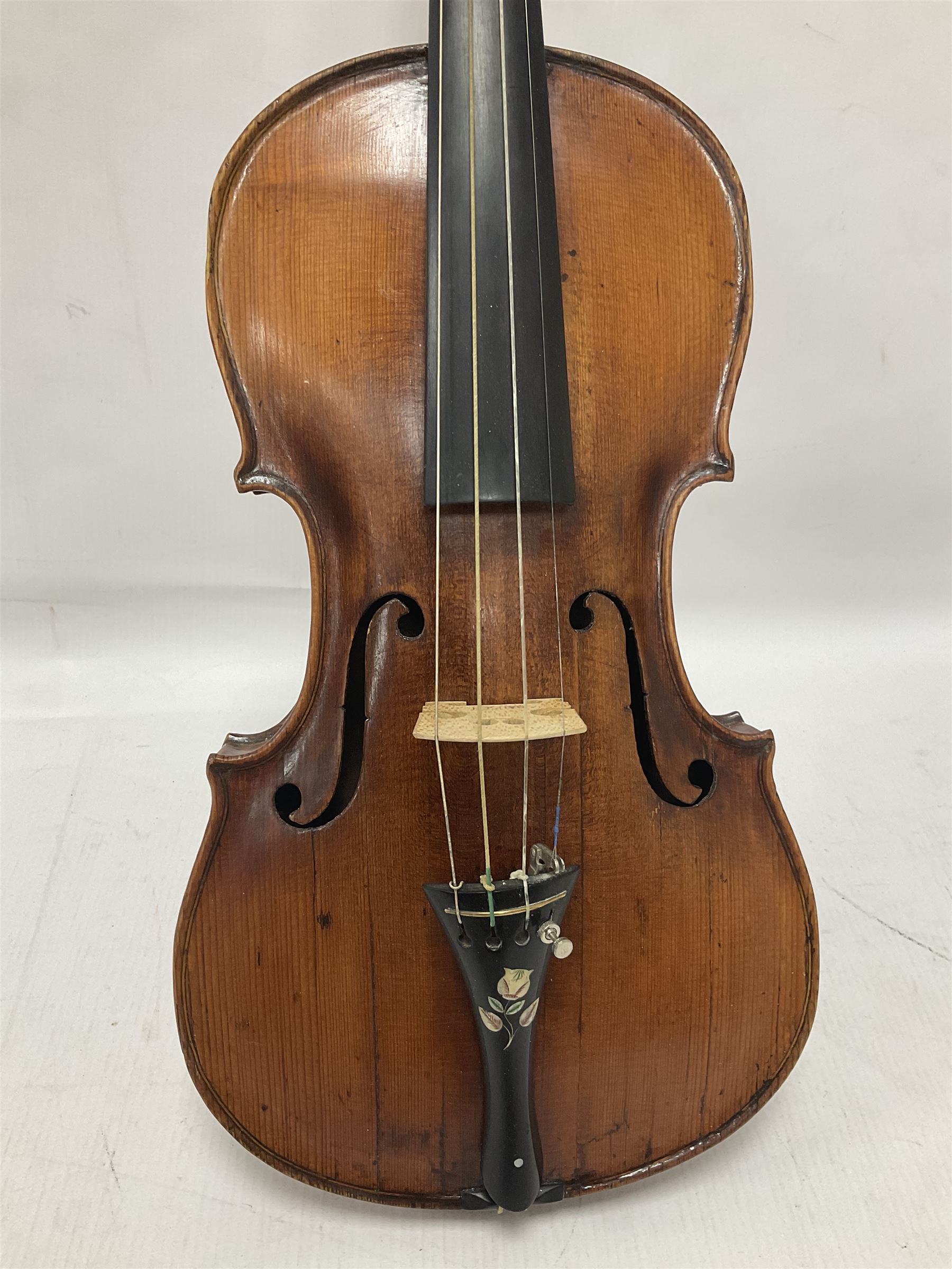 19th century full sized violin in a later hard case, decorative mother of pearl inlay to the tail piece Overall length 60cm No bow