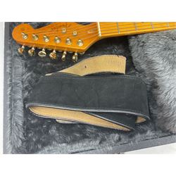 Copy of a Fender Stratocaster electric guitar in black with Wilkinson bridge, lock-in tuners, synchronised tremolo and various patent numbers; L99cm; in hard carrying case with strap and digital tuner