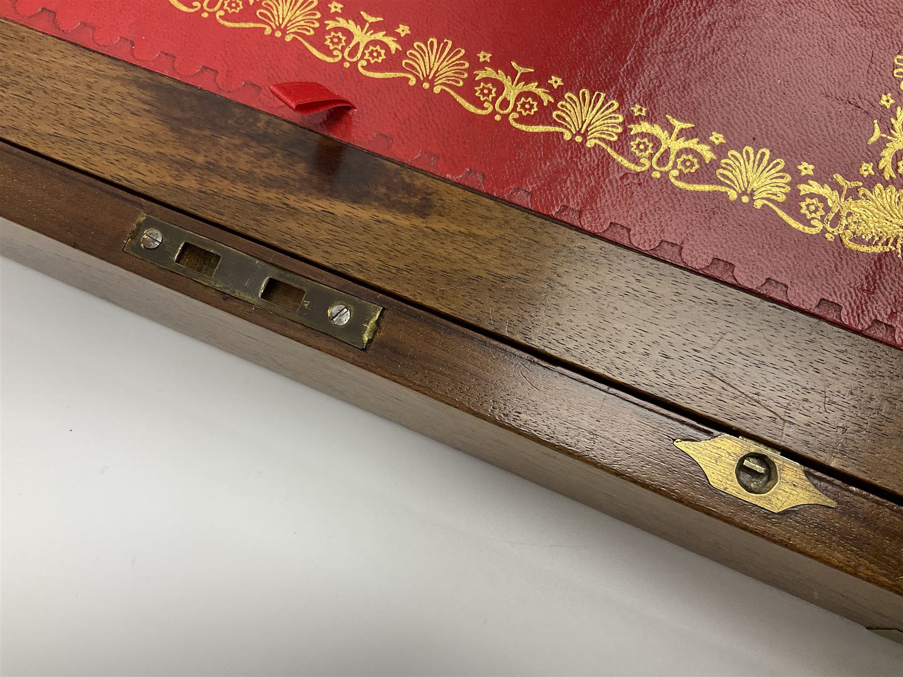 19th century burr yew wood tea caddy, of sarcophagus form, with strung details and brass mounts, the interior split into three compartments, upon four brass bun feet, together with an oak and brass bound writing slope, with red leather interior with gilt detailing, largest H16cm, W40cm