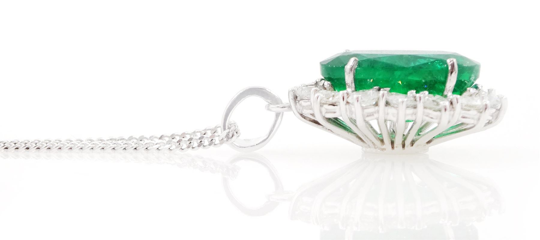 18ct white gold emerald and diamond pendant necklace, single oval cut  emerald of approx 3.25 carat, surrounded by fourteen round brilliant cut diamonds, on a fine link chain necklace, hallmarked, total diamond weight approx 0.50 carat