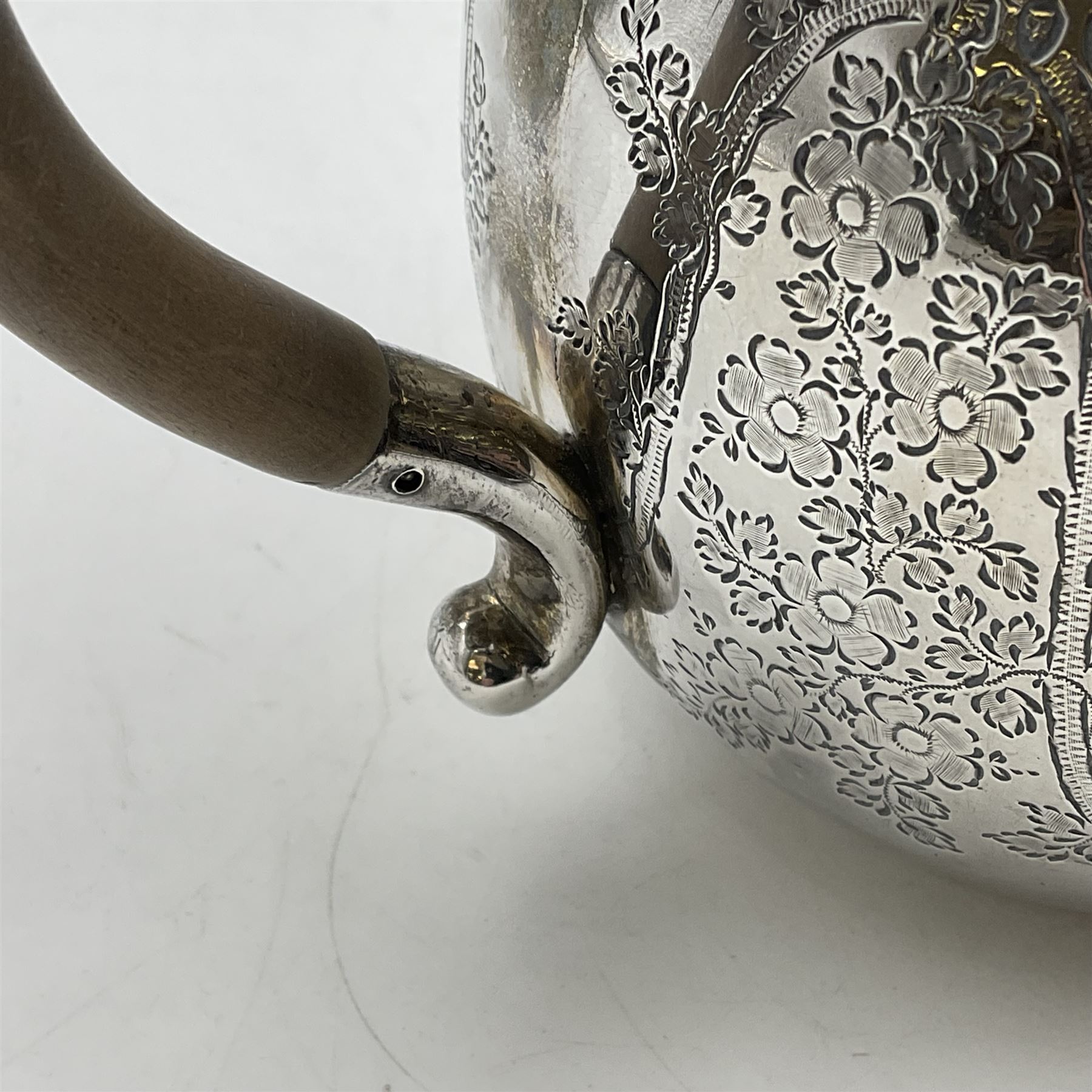 Late Victorian silver bachelors three piece tea service, comprising bullet shaped teapot, open sucrier and milk jug, each engraved with monogram surrounded by birds upon and amidst a blossoming vine, the teapot with scroll capped curved wooden handle and wooden finial to cover, hallmarked Wakely & Wheeler, London 1890, teapot including handle H12cm, sucrier H5.5cm 