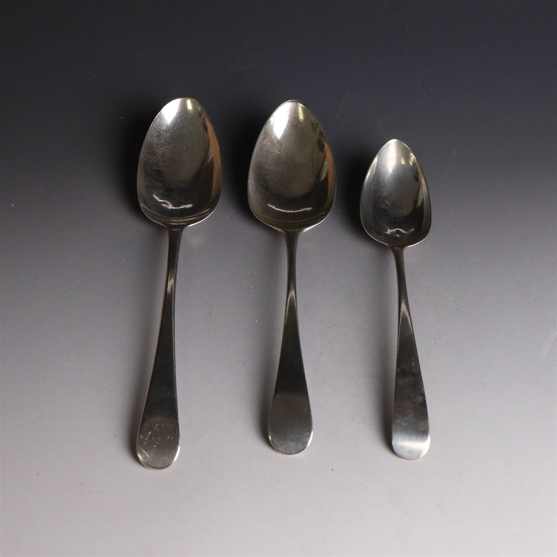 Three George III silver Old English pattern spoons, comprising table spoon with engraved monogram to terminal, hallmarked Thomas Wilkes Barker, London 1806, another table spoon hallmarked London 1806, and a Scottish silver dessert spoon hallmarked James Orr, Edinburgh 1805