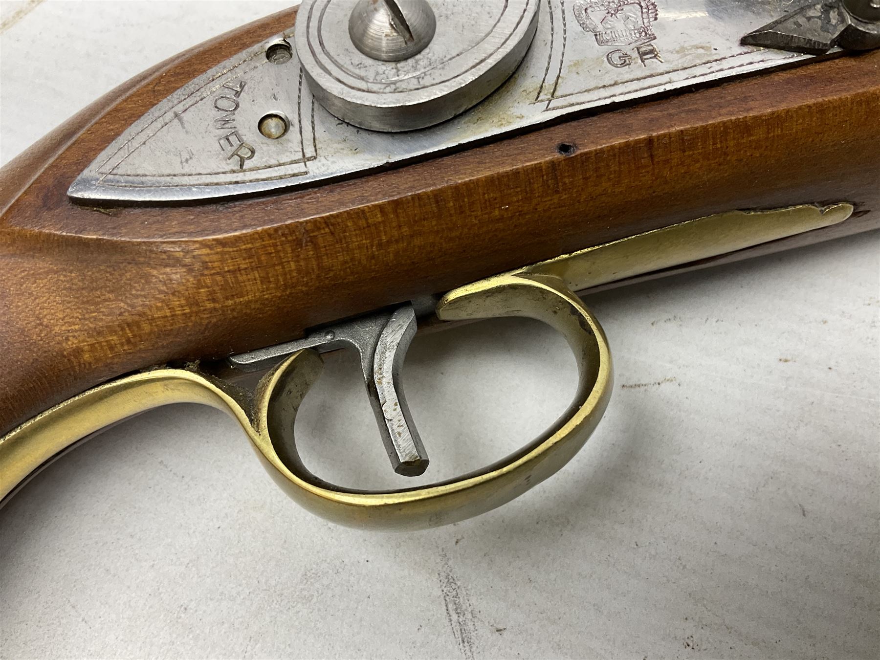 Reproduction non-firing flintlock pistol with brass skull crusher butt, the lock-plate inscribed 'Tower' and 'GR' L40cm; Sabre Japan Original Bowie Knife in sheath; and Indian embossed nickel two-piece walking cane (3)