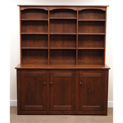  Ercol Provencal dresser with bookcase top in Golden Dawn elm finish, projecting cornice, six adjustable and three fixed shelves above three cupboards fitted interior, plinth base, W161cm, H193cm, D48cm  