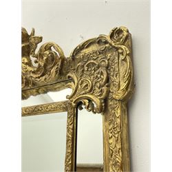 Large Victorian style gilt cushion framed mirror, putti holding urn with scrolled foliage pediment above central rectangular bevelled plate, the frame decorated with moulded foliate, each corner set with ornate cartouche