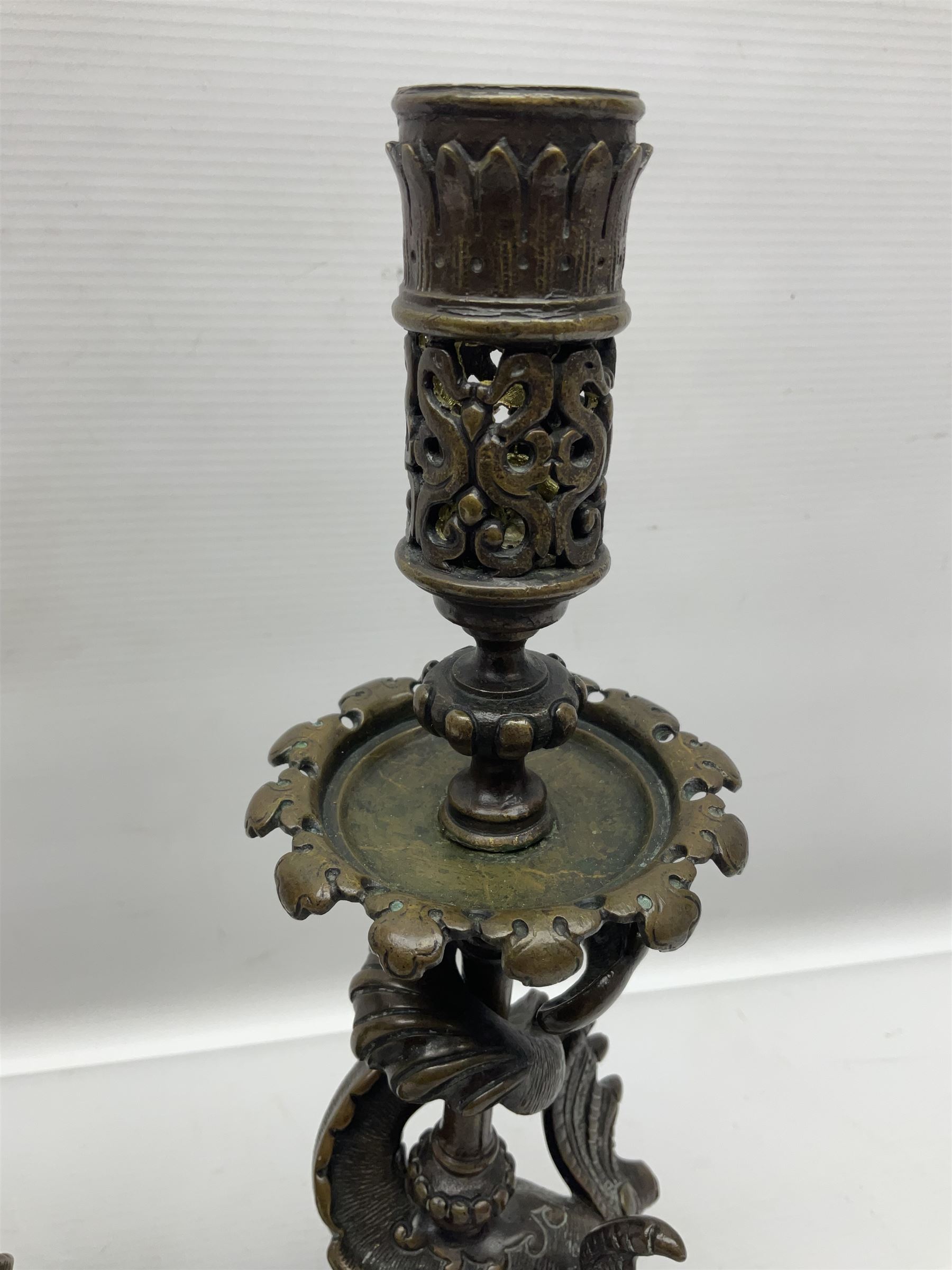 Pair of late 19th/ early 20th century brass candlesticks in the form of dolphins upon a stepped base with Fleur-de-lis design, H32cm 