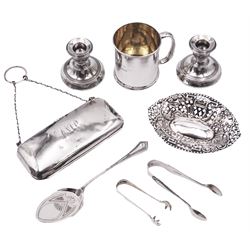 Group of silver, comprising small late Victorian dish, of oval form, the sides pierced with quatrefoil and lozenge shapes, and embossed with pagodas, bridge, birds and tree, hallmarked William M Hayes, Birmingham 1900, an Edwardian christening mug of cylindrical form with personal engraving and C handle, hallmarked London 1905, makers mark worn and indistinct, an early 20th century purse of plain oblong form with engraved monogram, suspension chain and leather compartmented interior, hallmarked Robert Pringle & Sons, Birmingham 1917, pair of 1920's silver mounted dwarf candlesticks, a late Victorian shovel spoon, pair of Victorian sugar tongs, and pair of 1920's sugar tongs, approximate weighable silver 5.12 ozt (159.2 grams)