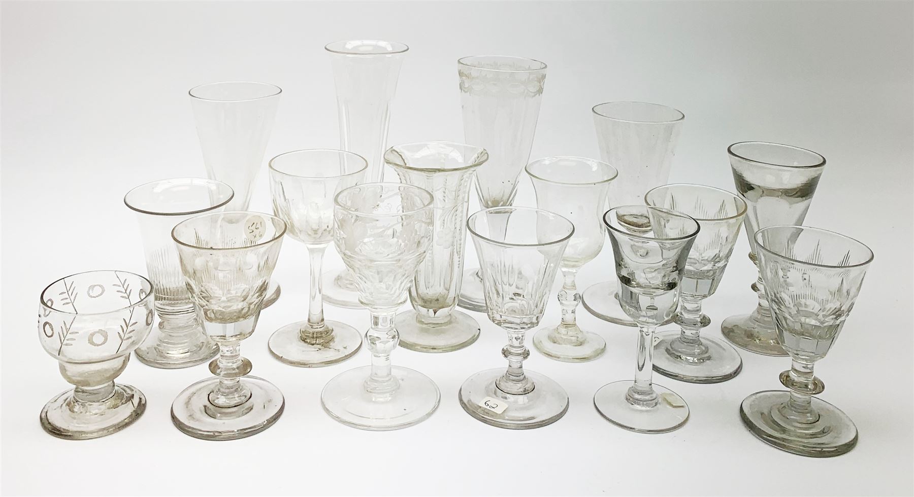 A group of early 19th century and later drinking glasses, to include two toastmaster type examples with deceptive bowls, together with a Bonnet glass or monteith, probably late 18th century. 