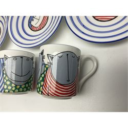 Modern studio pottery by Josie Firmin, to include cup and saucer, three espresso cups and saucers, pair of egg cups etc, each hand painted with varying cartoon cat designs