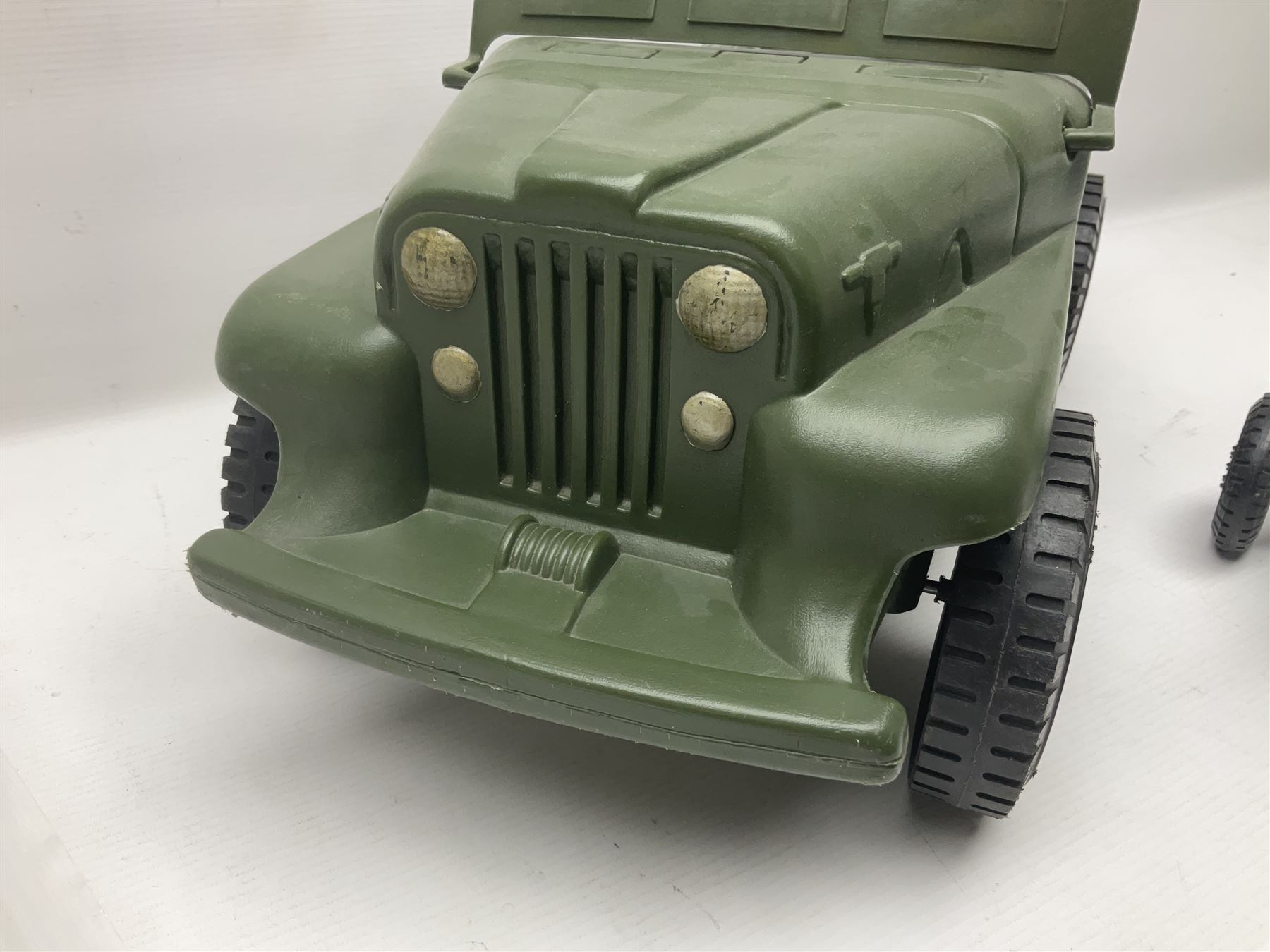 Action Man - five figures marked on the back 'Made in England by Palitoy under licence from Hasbro 1964', one dressed as a German Stormtrooper, one as a Red Devil Pilot and three in army uniform; another similar action figure marked to the right buttock ' G.I. Joe Copyright 1964 by Hasbro Patent Pending Made in Canada' dressed in army uniform; together with an Action Man jeep, field gun, mortar and machine guns and other accessories including helmets and weapons, parachute, diving equipment, skis and snow shoes, boots, uniforms etc; all unboxed