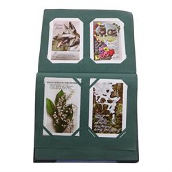 Collection of early 20th century postcards and greetings cards, including WWI embroidered silk Christmas card, black and white family photographs, 1920s birthday cards, black and white and colour postcards of Margate, Ramsgate, Blackpool etc, housed in three postcard albums