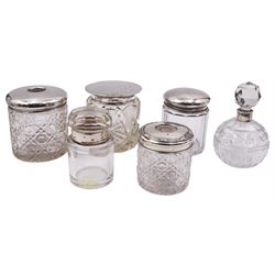 Group of silver mounted glass dressing table jars and bottles, to include an early 20th century hair tidy jar with octagonal and hobnail cut glass body and plain silver cover, hallmarked C C May & Sons, Birmingham 1912, H8cm, a 1920's cylindrical cut glass dressing table jar with plain flat topped silver cover, hallmarked Sheffield 1920, makers mark partly worn and indistinct, a further 1920's example with facet cut glass body and plain silver cover, hallmarked J & R Griffin Ltd, Chester 1921, etc., (6)